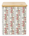 Storage container with floral pattern and wooden lid on a white background