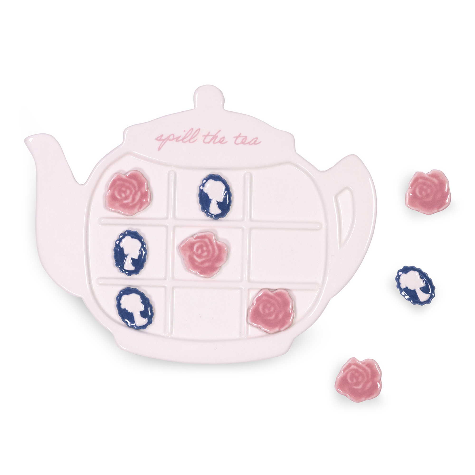 Teapot-shaped tic-tac-toe game with floral designs on a lace tablecloth