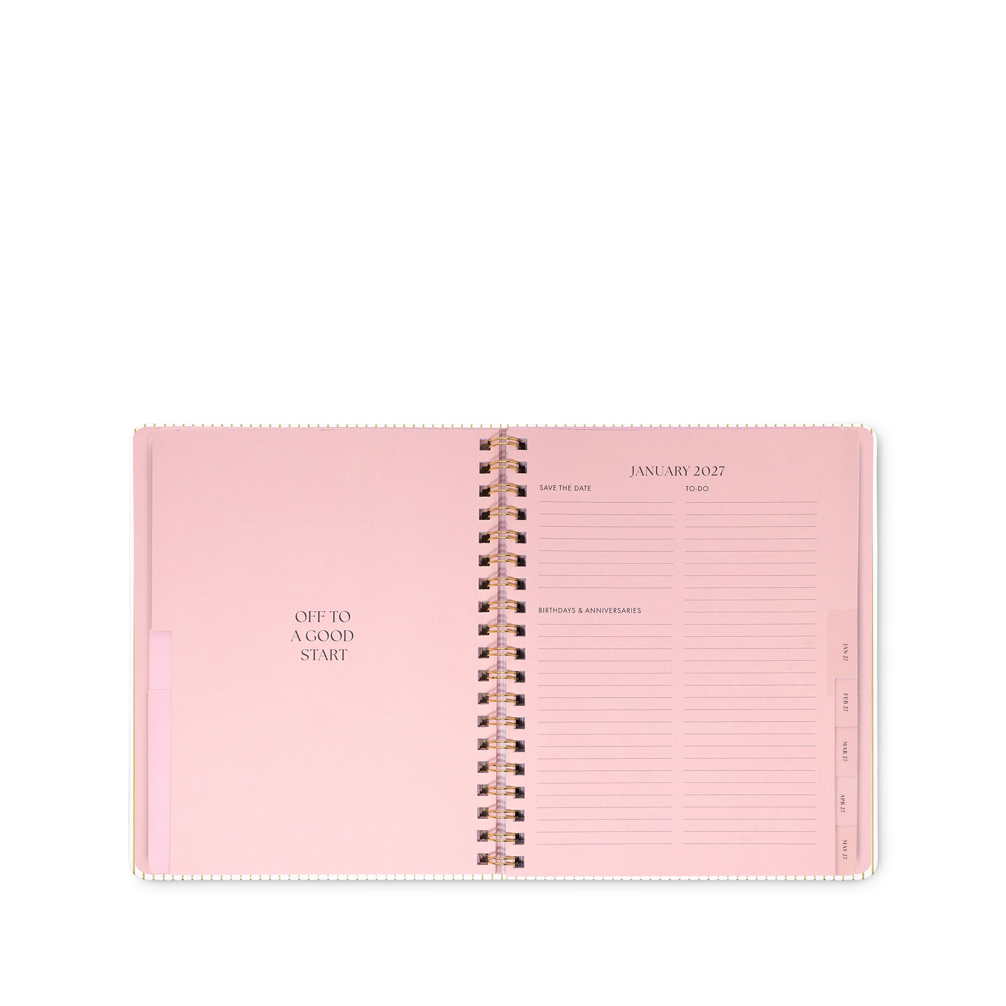 An open spiral-bound planner in light pink, showing the January 2023 weekly layout page on the right and a blank left page with the text 'OPEN TO A GOOD START' on the left. The pages are held together by a metallic spiral.