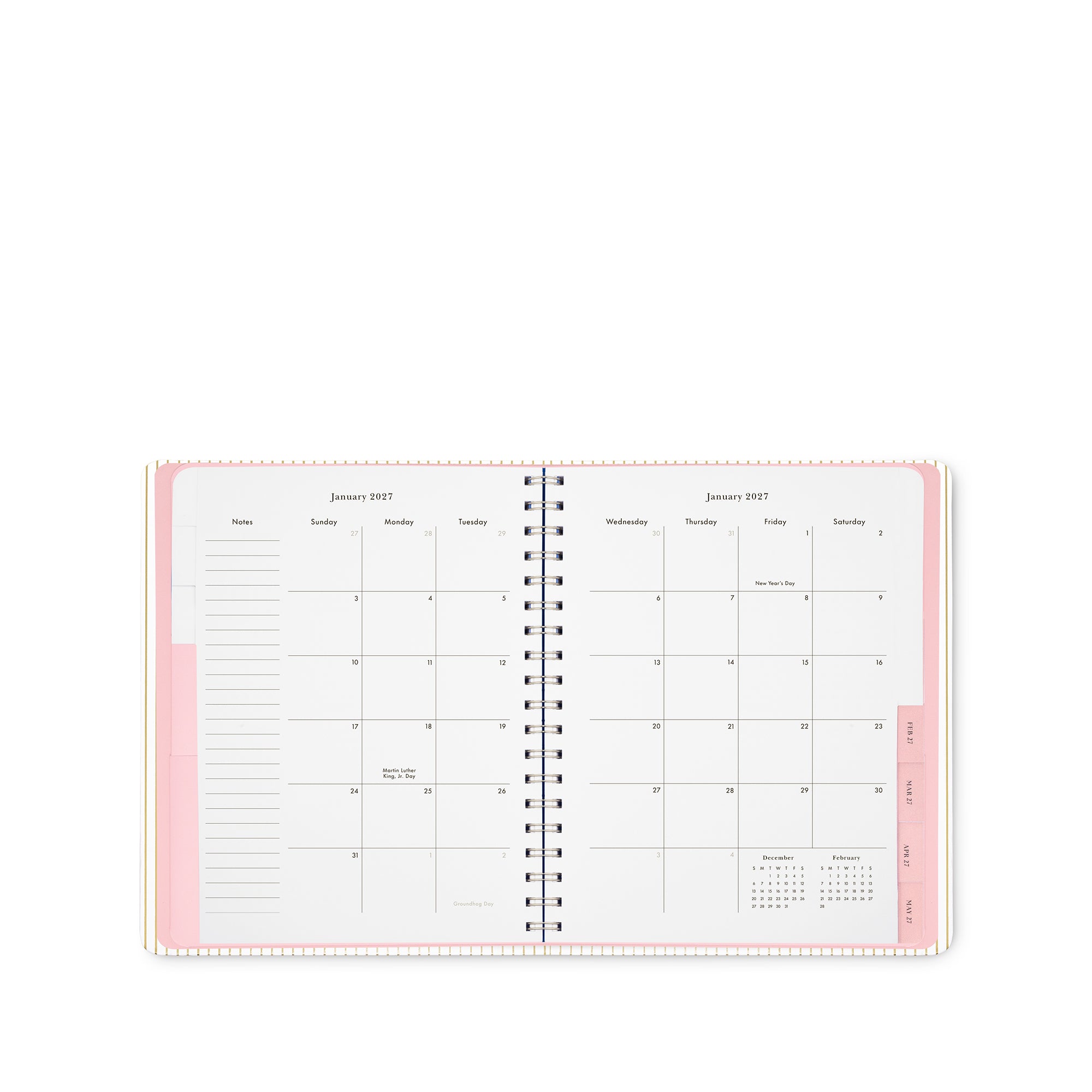 An open spiral-bound planner showing a monthly calendar spread with pink accents on a clean white background.