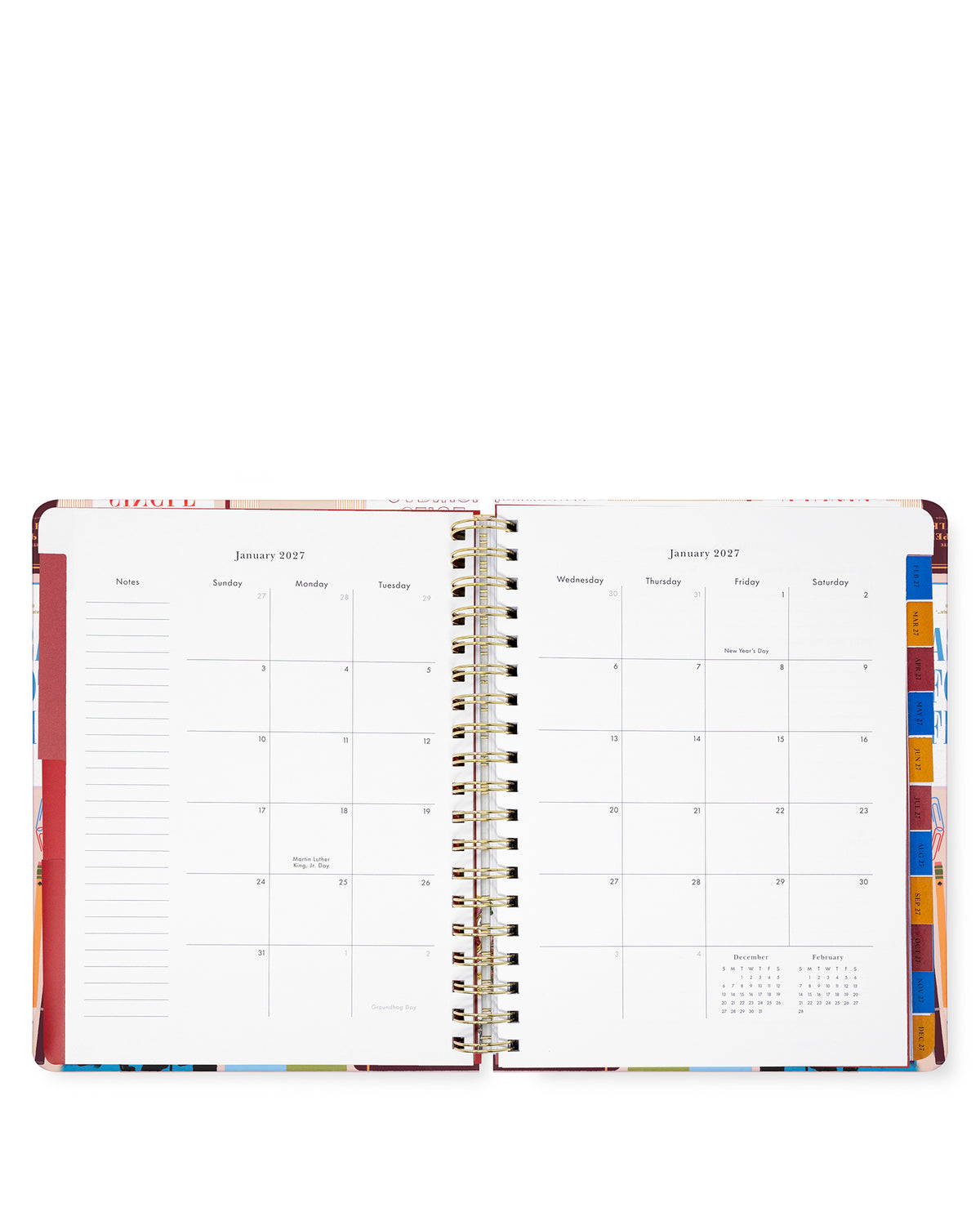 An open spiral-bound planner or calendar showing two monthly calendar spreads for January 2027, with lined daily sections on the left page and colorful tab dividers on the right, photographed on a white background.