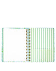 Notebook with a colorful cover and green striped pages on a white background