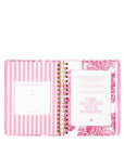 Open planner with pink and white design on a white background