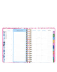 Planner with colorful tabs and a floral design on a white background
