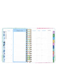 Open planner showing weekly and daily schedules with colorful tabs on a white background