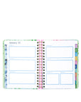 Open planner showing a weekly layout with colorful tabs on a white background