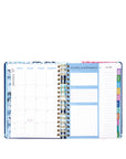 Open planner with monthly and weekly layout on a white background