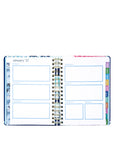 Open planner with colorful tabs on a white background