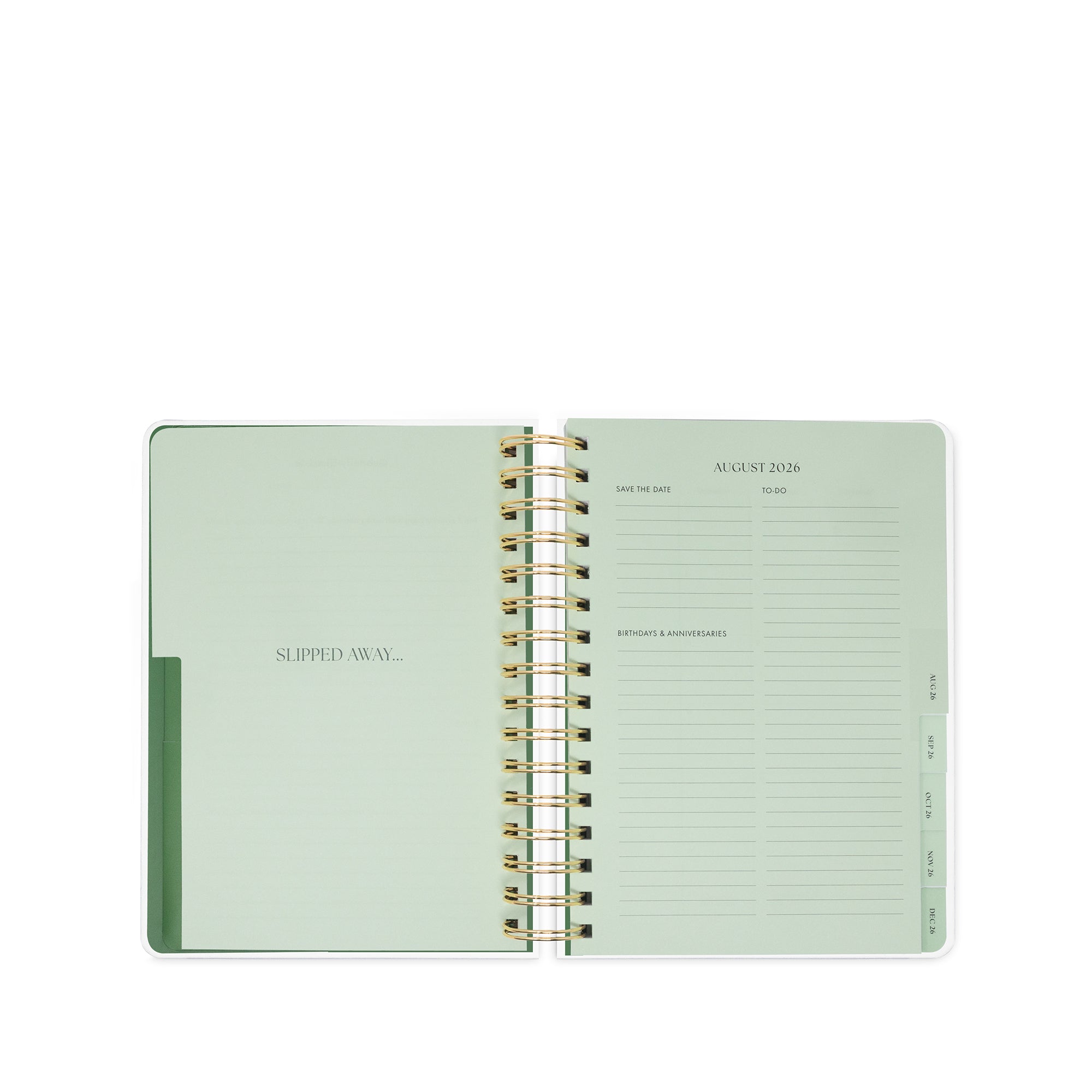 Open green planner with gold spiral binding on a white background