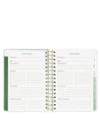 Open planner with vacation planner section on a white background