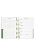 Wiro-bound planner with weekly and monthly layout on a white background