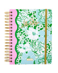 Floral patterned planner with gold spiral binding on a white background