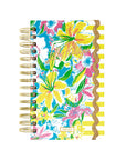 Floral planner with gold rings on a white background