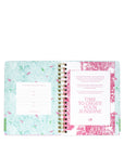 Open planner with floral design on a white background