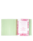 Spiral-bound notebook with green striped cover and pink floral design on white background