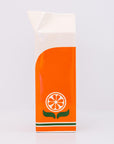 Orange and white orange juice vase with a design on a light gray background