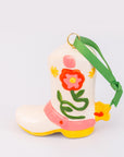 Decorative boot with floral design and green strap on a white background