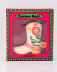 Decorative cowboy boot ornament in a pink box with floral designs on a white background