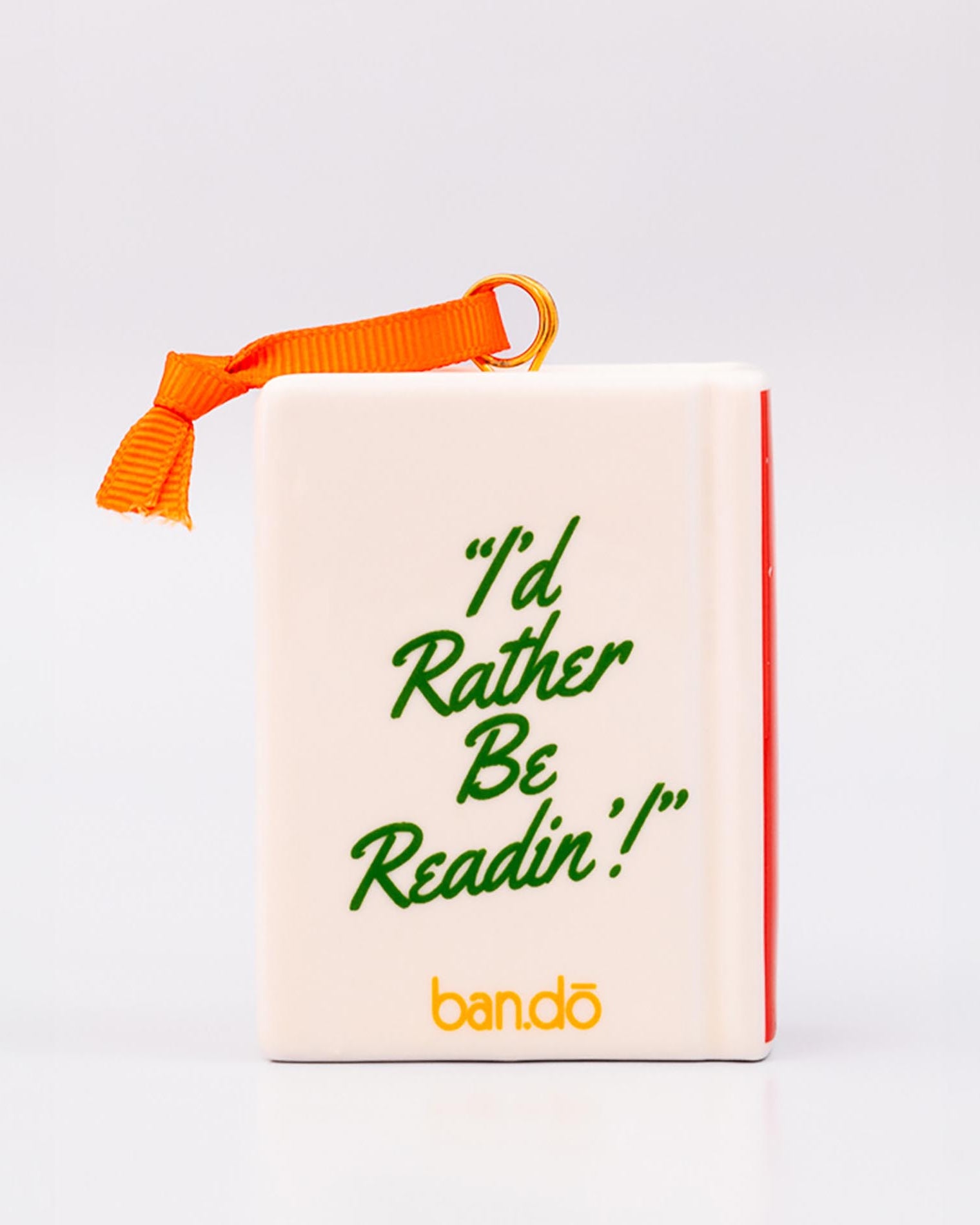Backview of ornament with 'THERE'S A REALLY GOOD PLOT TWIST IN HERE' and an orange hanger on a white background
