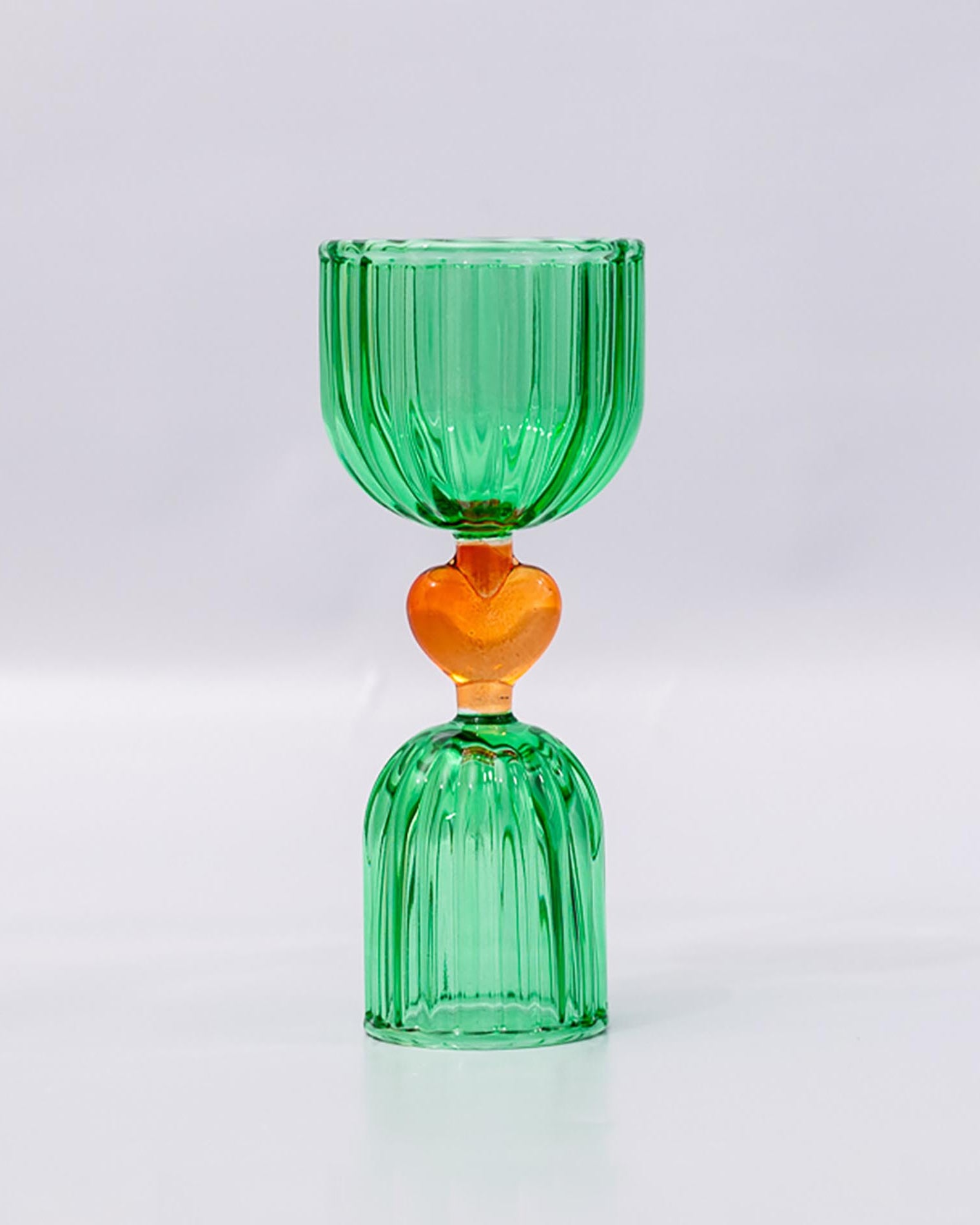 Green glass shot glass with yellow heart center
