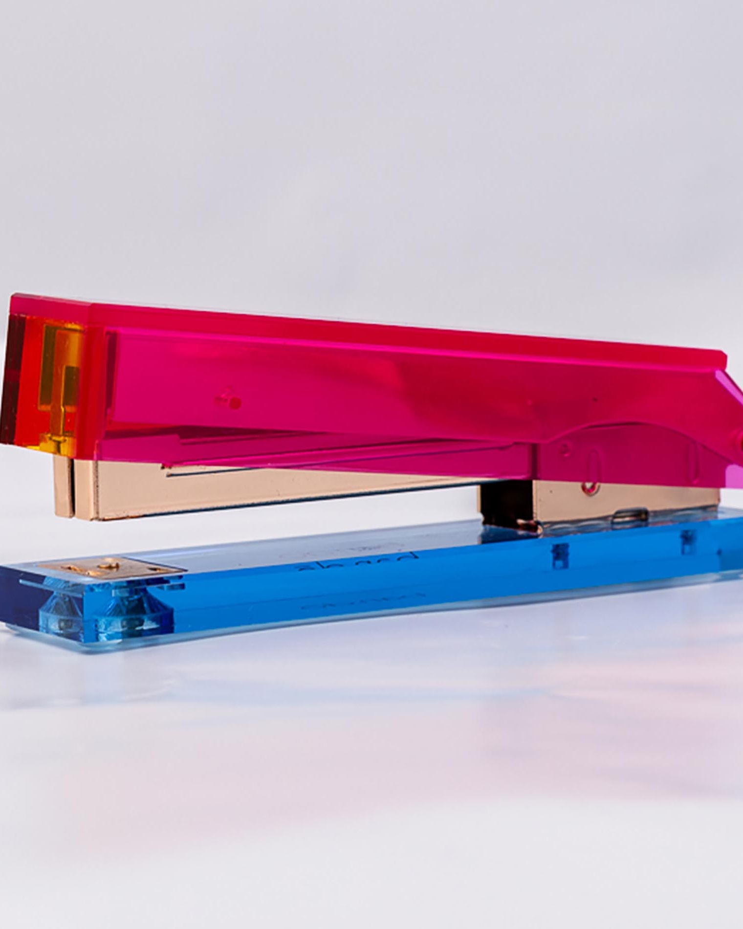 Colorful stapler with pink and blue design on a white background