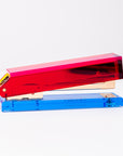 Colorful stapler with red and blue components on a white background