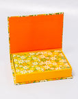 Open box with orange top and floral-patterned bottom on a white background
