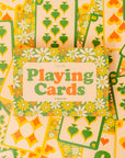 Set of playing cards with floral and nature-themed design, featuring hearts, flowers, and leaves.