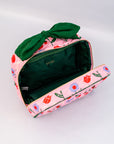 Floral-patterned pouch with a green bow on a light gray background