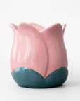 Pink and teal ceramic tulip-shaped vase on a white background
