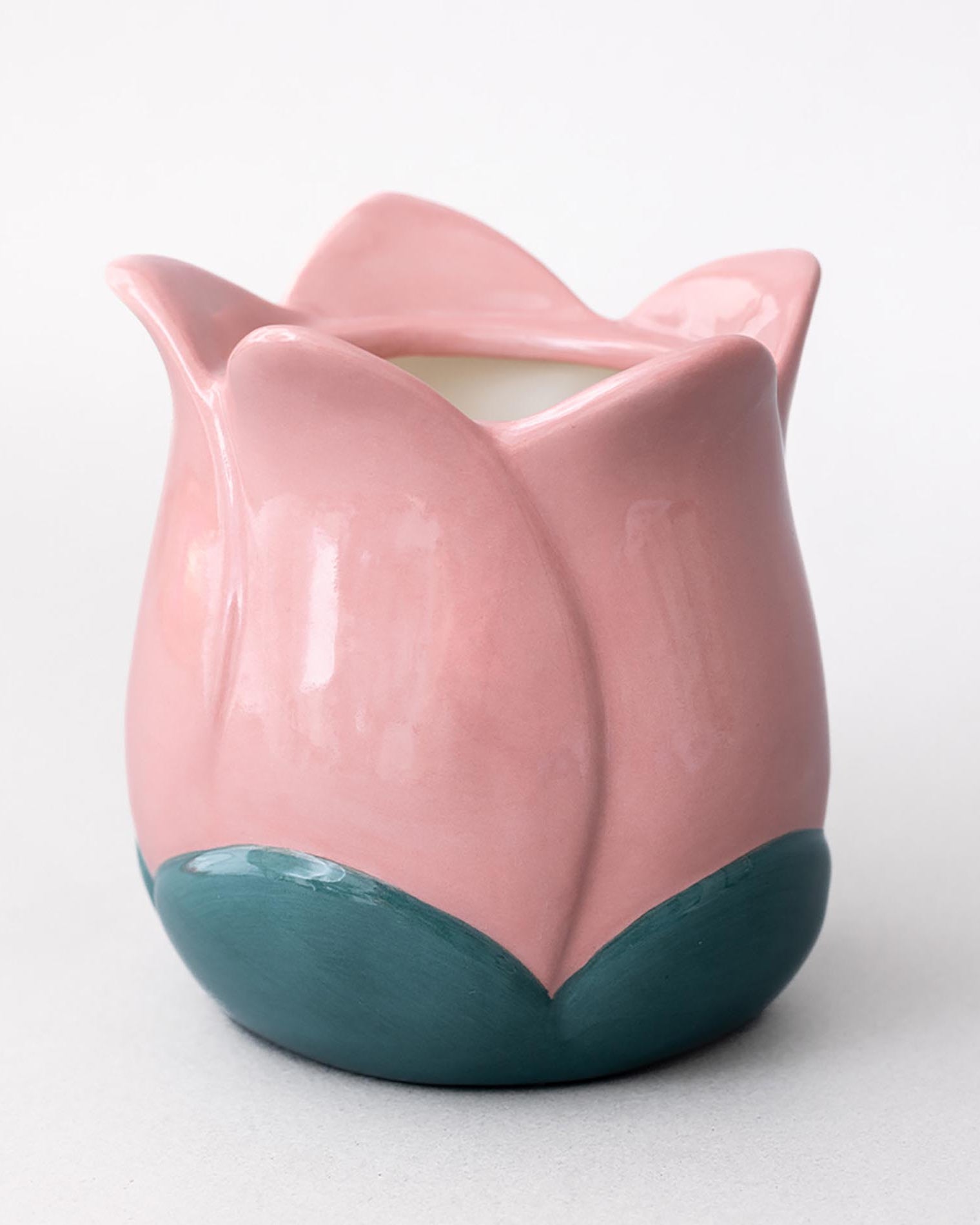 Pink and teal ceramic tulip vase on a white background