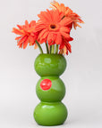 Green vase with orange flowers on a white background