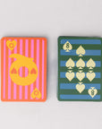 Two playing cards with colorful designs on a light gray background
