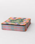 Stack of colorful playing cards with a geometric pattern on a white background