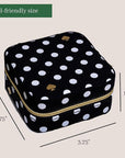 Black polka dot travel-sized product case with measurements on a beige background