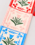 Decorative bookmark with floral patterns and tassels on a light gray background