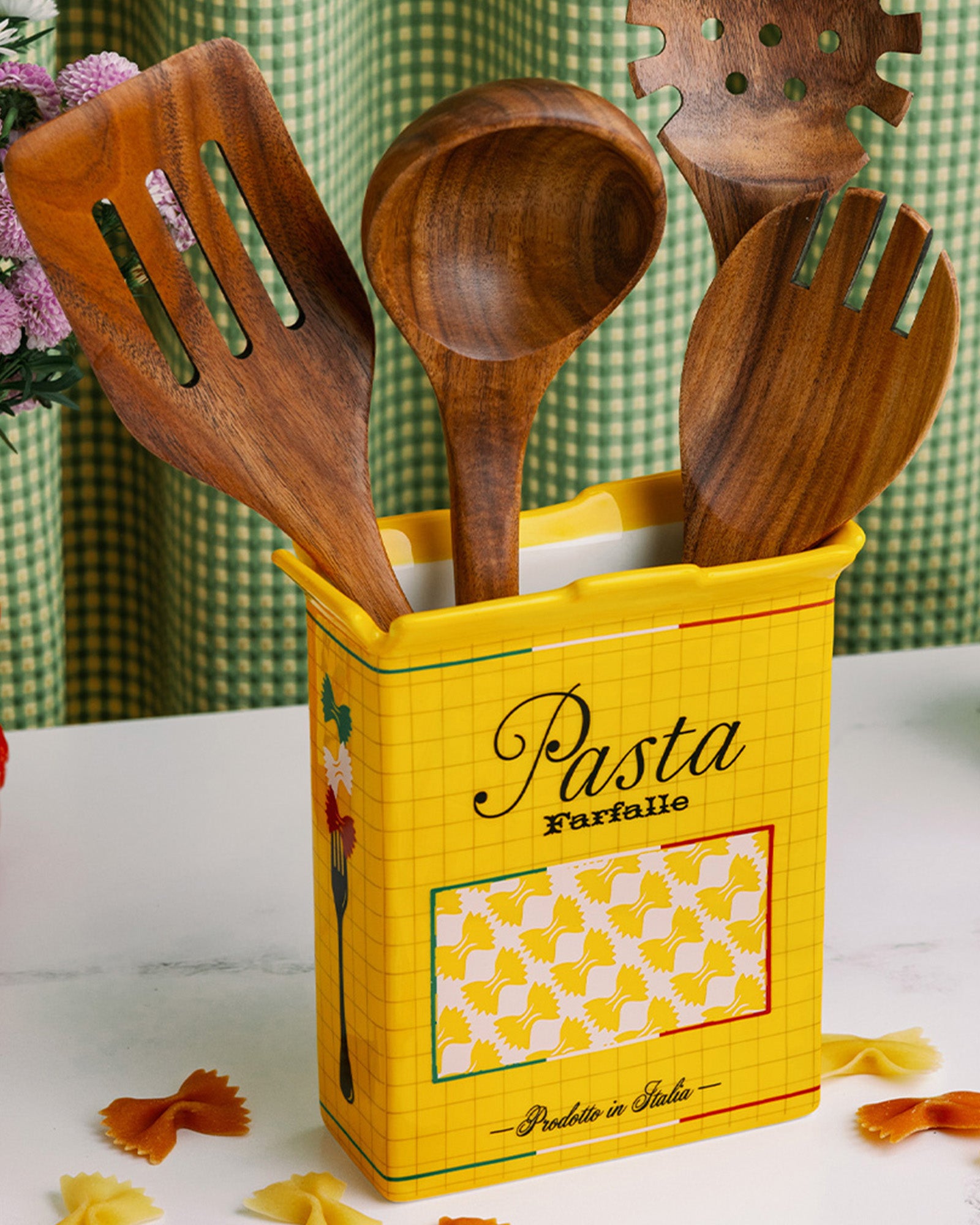 yellow pasta box vase with wooden utensils inside