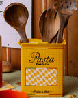 yellow pasta box vase with wooden utensils inside