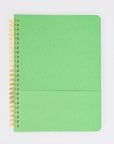 green interior pocket of cream mini notebook with colorful folk graphics and 'i'd rather be home reading' across the center
