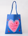 Blue tote bag with pink heart design and text on a white background
