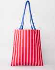 Red and white striped tote bag with blue handles on a light gray background