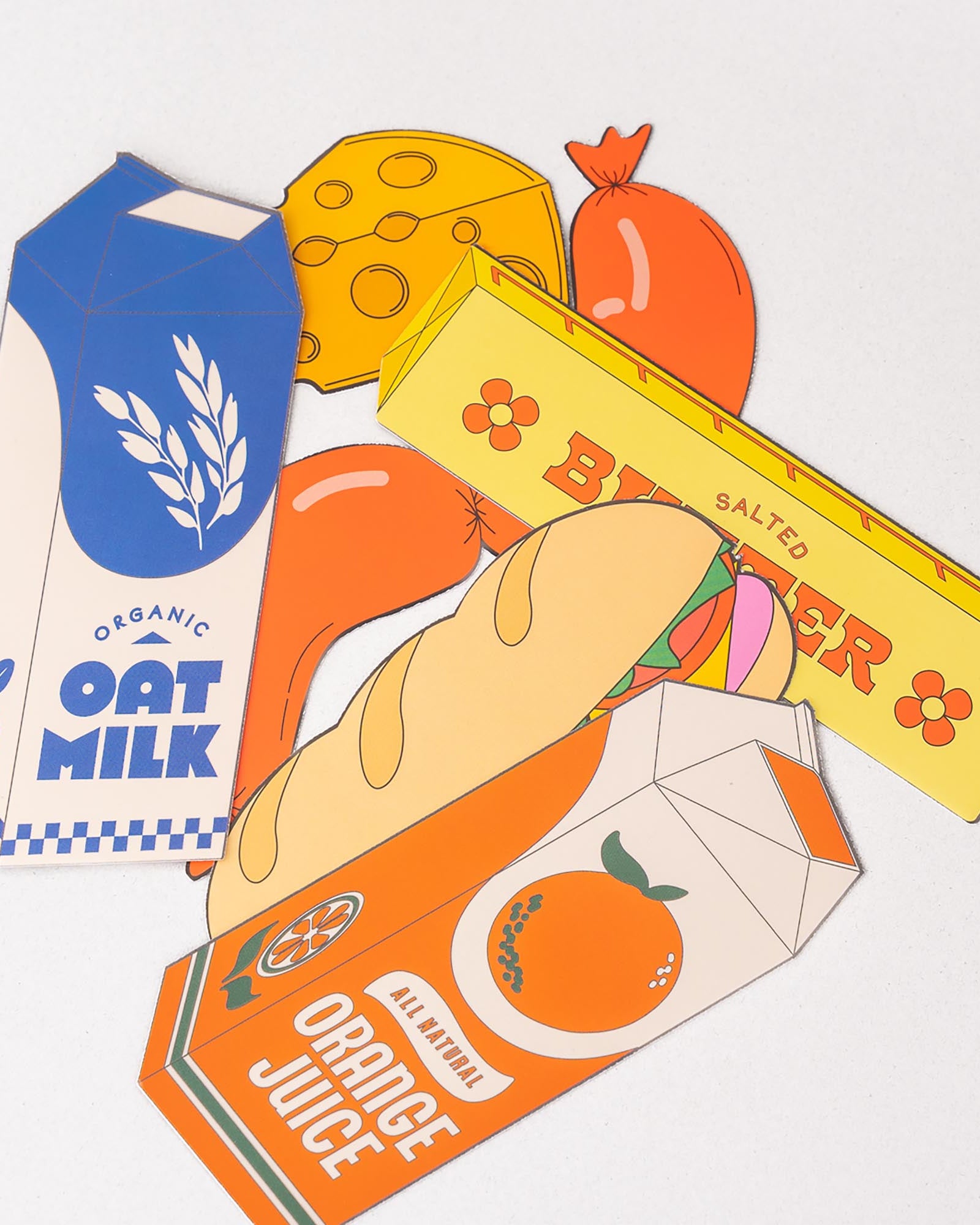 Illustrations of oat milk, orange juice, and a bar of butter on a white background