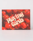 Playing card set packaging with red cherries on a white background