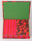 Colorful box with a green lid, pink and red striped paper, and cherry design.