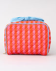 Quilted makeup bag with pink and orange pattern on a light gray background