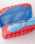 Red and pink pouch with blue interior and bow on a white background
