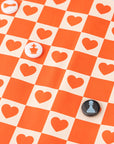 Checkered board with heart patterns and chess piece buttons on an orange and beige checkered background