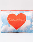 Pouch with a red heart and 'Romantique' text on a blue sky with clouds background
