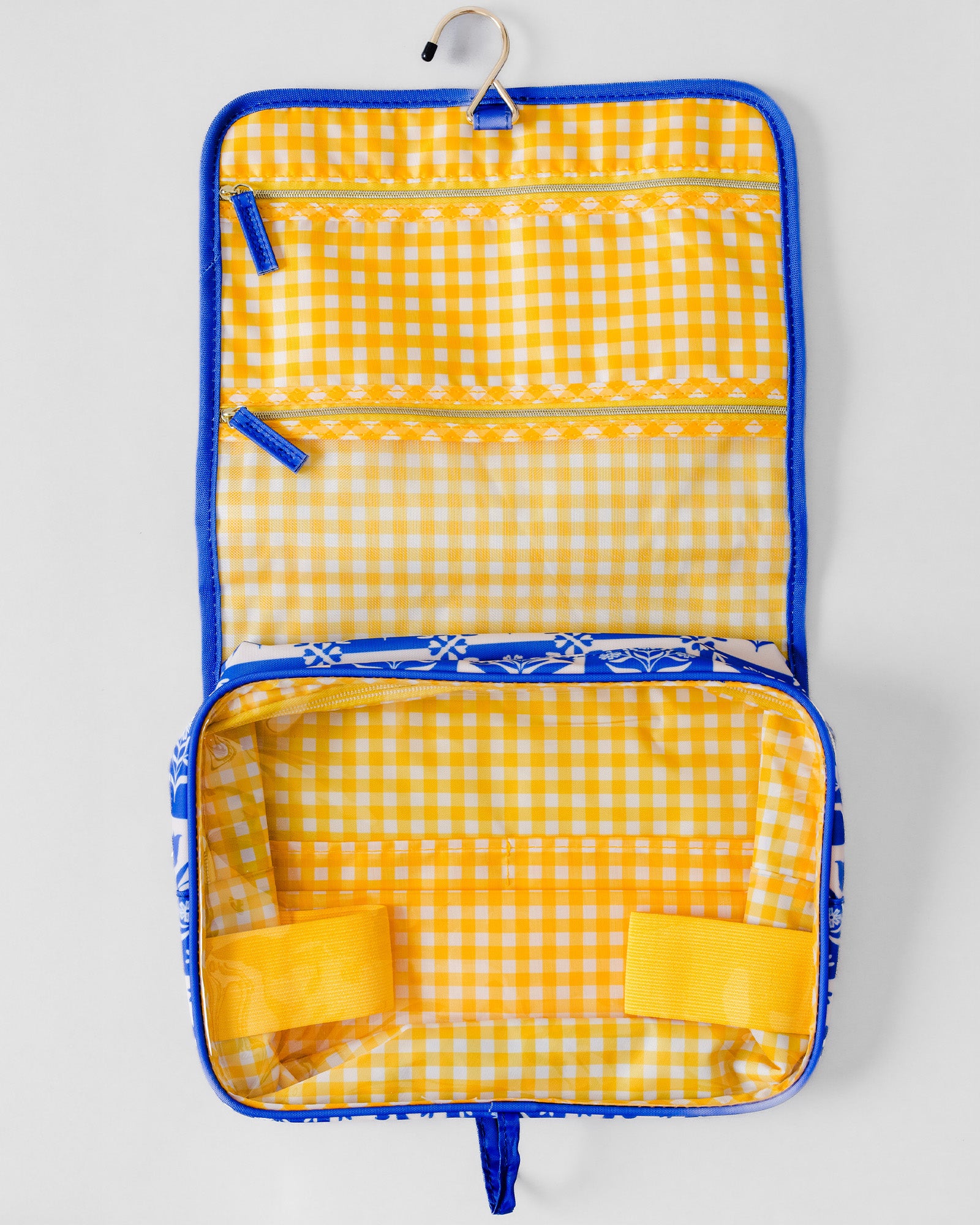 A yellow and white gingham check hanging organizer bag with blue trim, shown open on a light gray background.