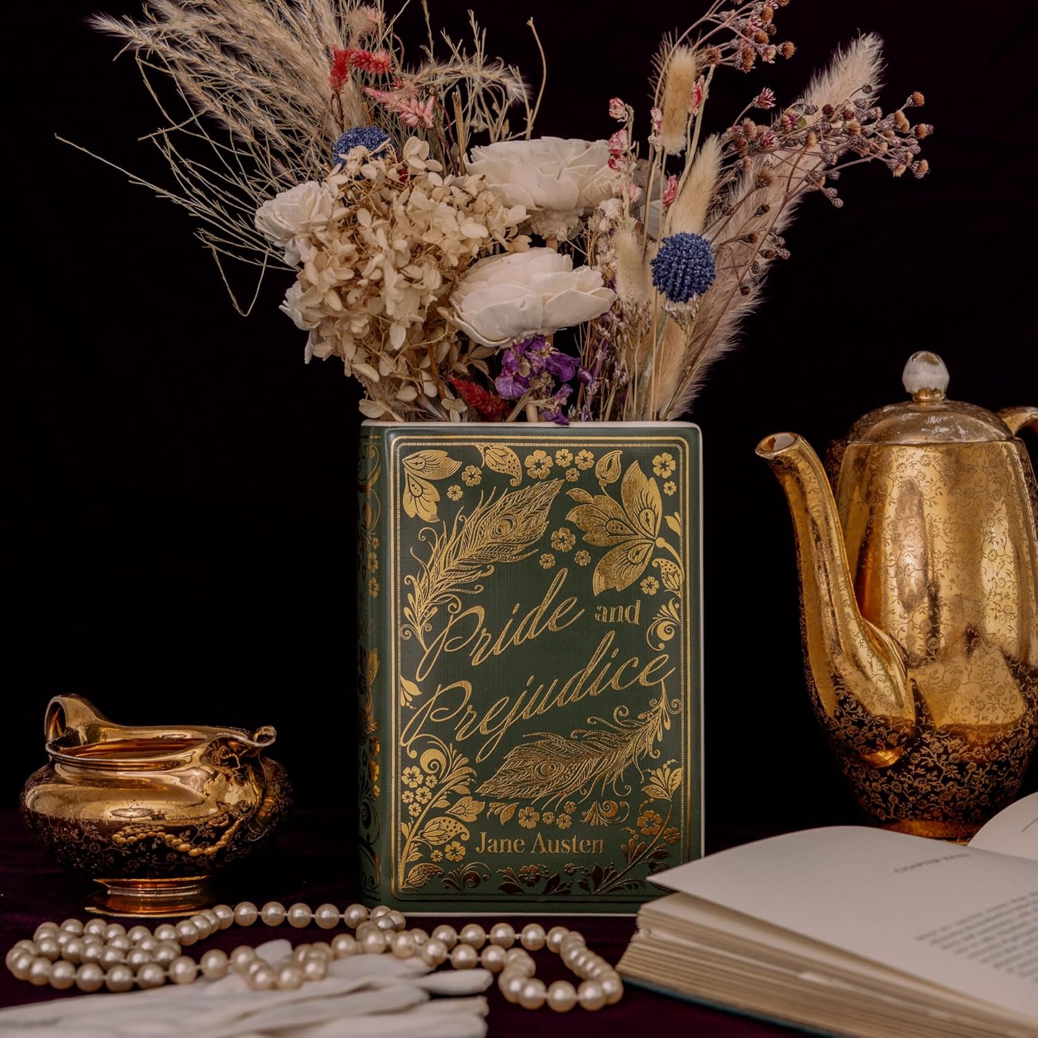 Book titled 'Pride and Prejudice' by Jane Austen with decorative elements on a dark background